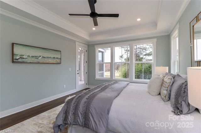 bedroom featuring crown molding, baseboards, wood finished floors, recessed lighting, and a raised ceiling