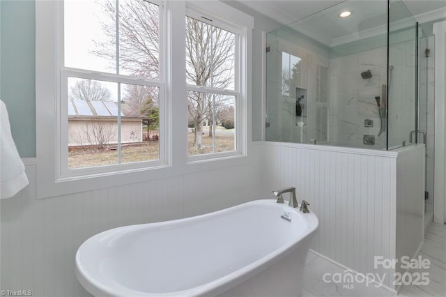 full bathroom featuring a wainscoted wall, recessed lighting, a freestanding tub, and a shower stall
