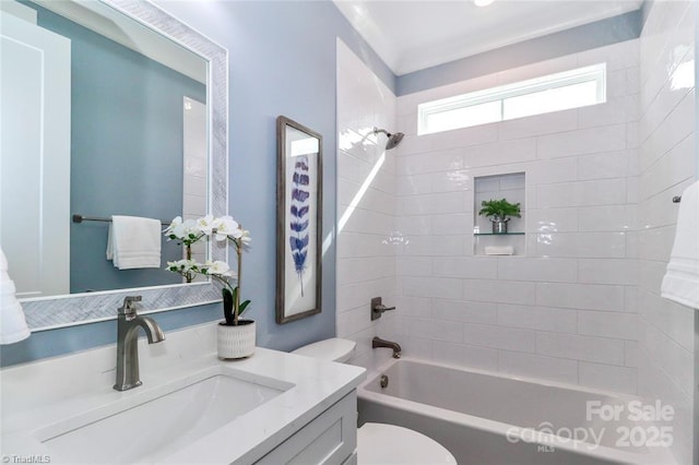 full bath with toilet, vanity, ornamental molding, and shower / bathing tub combination