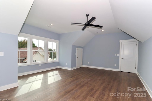 bonus room featuring baseboards, lofted ceiling, and dark wood-type flooring