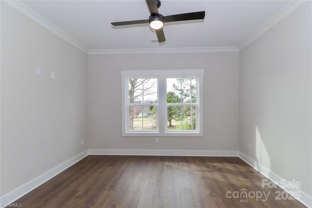 spare room with baseboards, a ceiling fan, crown molding, and dark wood finished floors