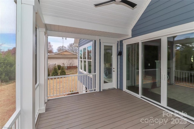 unfurnished sunroom featuring a ceiling fan