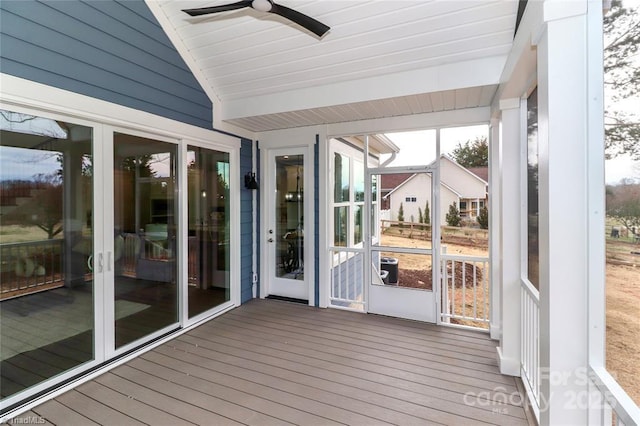 unfurnished sunroom with a ceiling fan