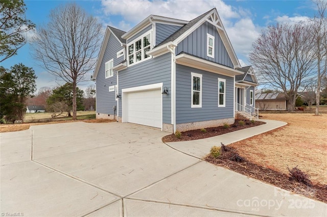view of home's exterior featuring board and batten siding, concrete driveway, crawl space, and a garage