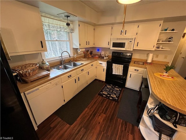 kitchen featuring sink, dark hardwood / wood-style floors, white appliances, white cabinets, and pendant lighting