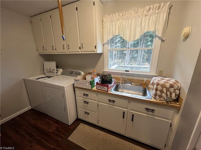 washroom featuring cabinets, dark hardwood / wood-style flooring, sink, and washing machine and clothes dryer