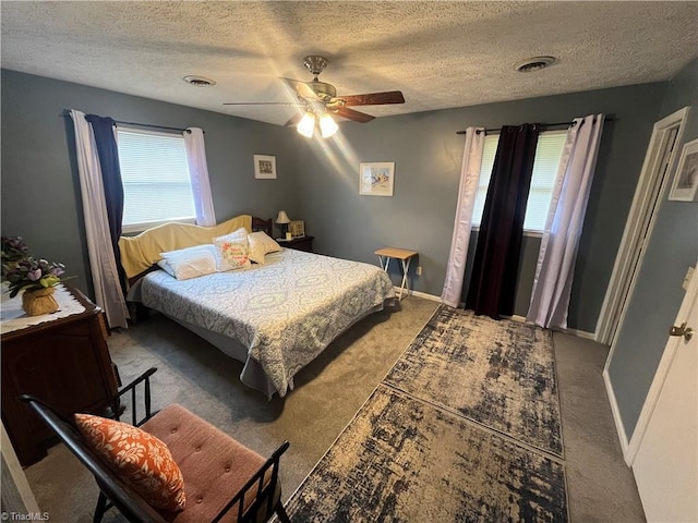 carpeted bedroom with a textured ceiling and ceiling fan