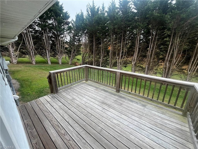 wooden terrace featuring a yard