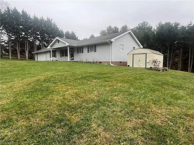 rear view of house with a storage unit and a lawn