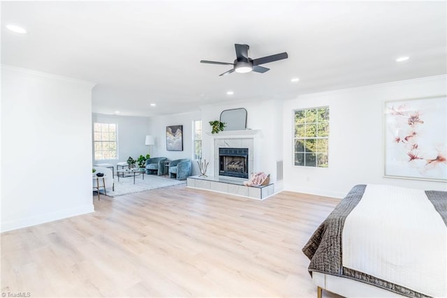 4114 Rose Lake Dr, Greensboro, NC 27407 - bedroom with ornamental molding, light wood-type flooring, a fireplace, and multiple windows