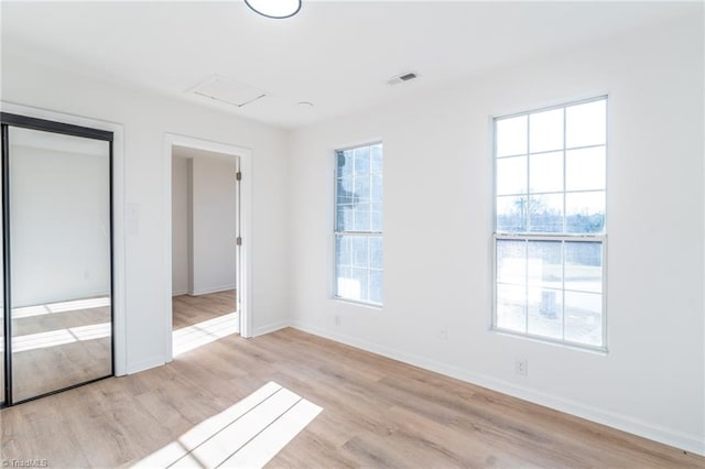 4114 Rose Lake Dr, Greensboro, NC 27407 - unfurnished bedroom with multiple windows and light hardwood / wood-style flooring