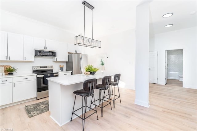 4114 Rose Lake Dr, Greensboro, NC 27407 - kitchen with appliances with stainless steel finishes, a kitchen breakfast bar, decorative light fixtures, white cabinets, and a kitchen island