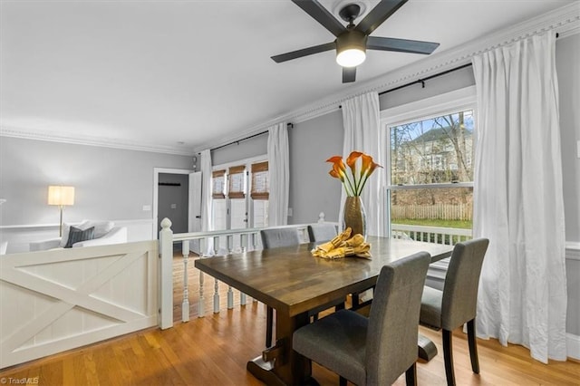 dining space featuring ceiling fan, crown molding, and light wood finished floors