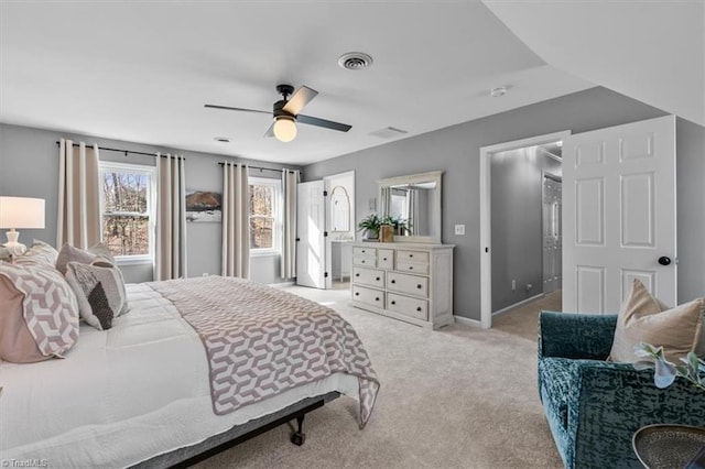 bedroom featuring visible vents, baseboards, light colored carpet, and a ceiling fan