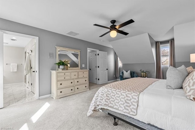 bedroom featuring vaulted ceiling, baseboards, visible vents, and light carpet