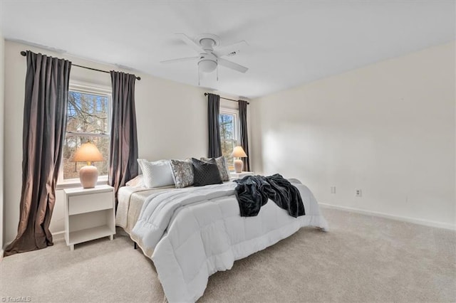 bedroom with baseboards, light colored carpet, and a ceiling fan