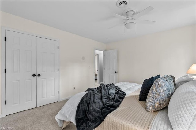 carpeted bedroom with baseboards, visible vents, a closet, and ceiling fan