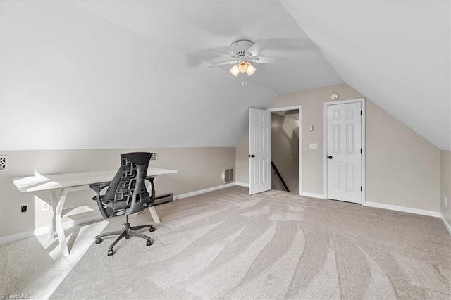 carpeted office space with visible vents, ceiling fan, baseboards, and vaulted ceiling