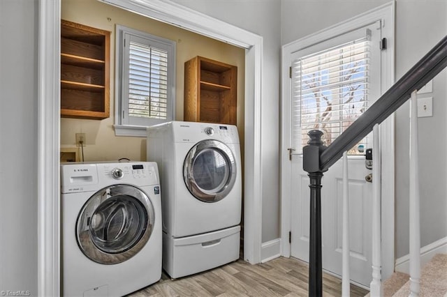 laundry room with light wood-type flooring, independent washer and dryer, and laundry area