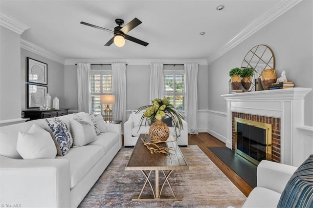 living area featuring a healthy amount of sunlight, wood finished floors, and ornamental molding