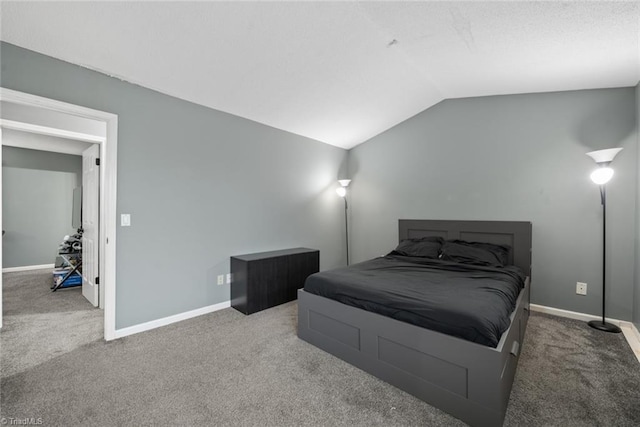 bedroom with lofted ceiling and carpet floors