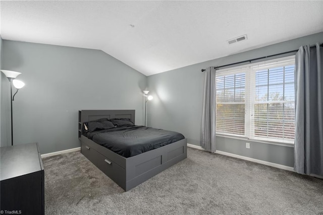 bedroom featuring dark colored carpet and vaulted ceiling