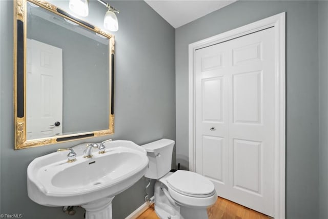 bathroom featuring hardwood / wood-style floors and toilet