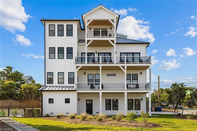 exterior space featuring a balcony and a front lawn