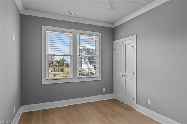 101 Melanie St, Emerald Isle, NC 28594 - spare room with ornamental molding, light wood-style floors, visible vents, and baseboards