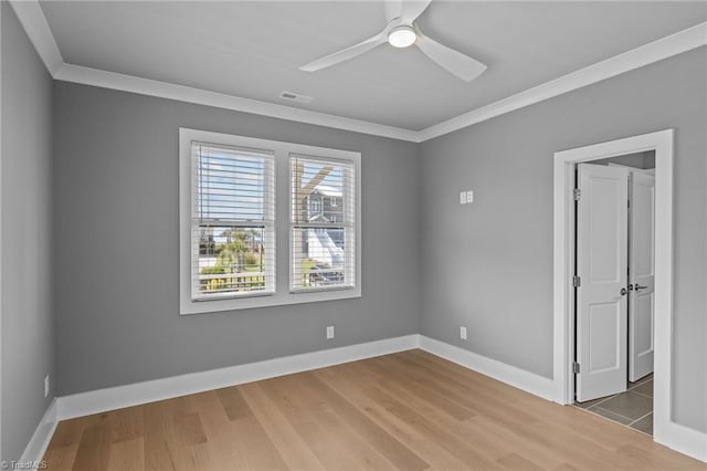 spare room with crown molding, hardwood / wood-style flooring, and ceiling fan