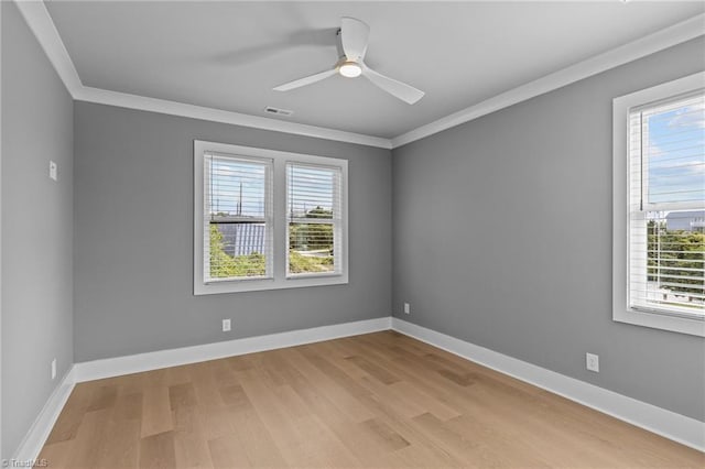 empty room with light hardwood / wood-style floors, ornamental molding, and ceiling fan