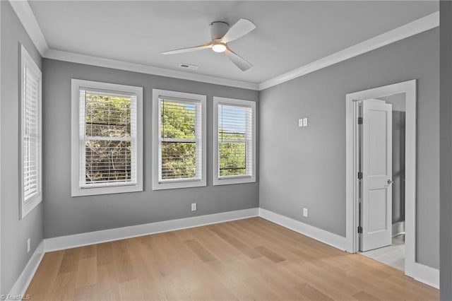 unfurnished room with a healthy amount of sunlight, crown molding, light hardwood / wood-style floors, and ceiling fan