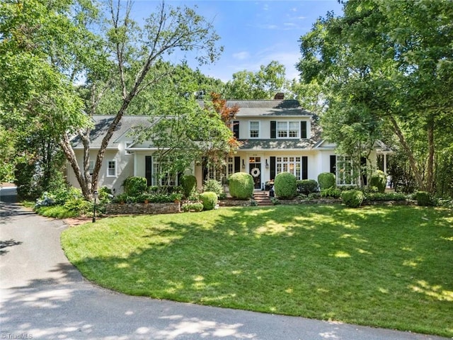 2792 Fieldwood Ct, Winston-Salem, NC 27106 - view of front of home with a front yard, a chimney, and stucco siding