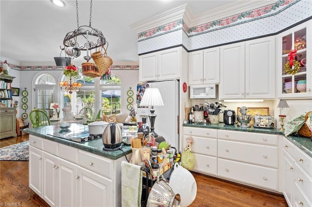 2792 Fieldwood Ct, Winston-Salem, NC 27106 - kitchen with white appliances, wallpapered walls, a chandelier, wood finished floors, and dark countertops