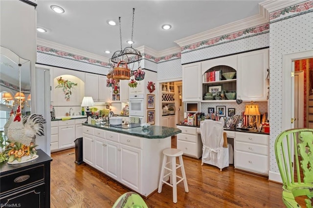 2792 Fieldwood Ct, Winston-Salem, NC 27106 - kitchen featuring wallpapered walls, ornamental molding, white cabinets, open shelves, and dark countertops