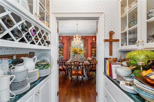 2792 Fieldwood Ct, Winston-Salem, NC 27106 - kitchen featuring wood finished floors, a chandelier, glass insert cabinets, and white cabinetry