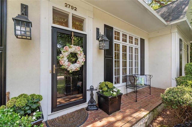 2792 Fieldwood Ct, Winston-Salem, NC 27106 - doorway to property featuring stucco siding, a shingled roof, and covered porch