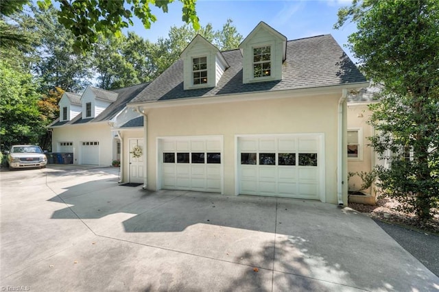 2792 Fieldwood Ct, Winston-Salem, NC 27106 - view of front facade with driveway, stucco siding, an attached garage, and roof with shingles