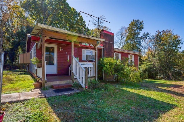 view of outbuilding featuring a yard and a porch