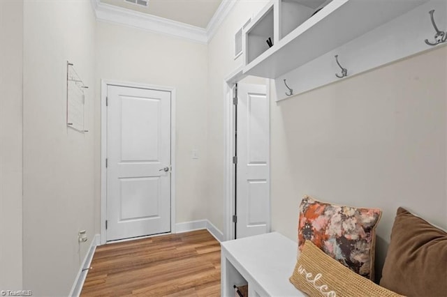 mudroom with light hardwood / wood-style flooring and crown molding