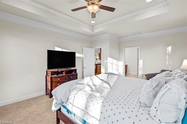 carpeted bedroom featuring ceiling fan, ornamental molding, and a tray ceiling