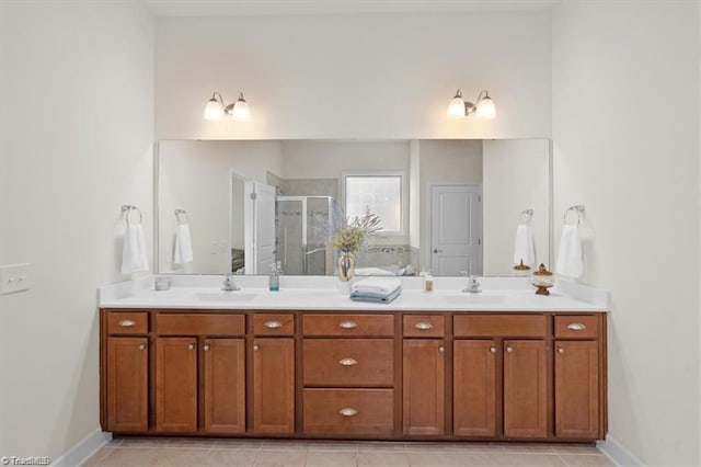 bathroom with tile patterned flooring, vanity, and walk in shower