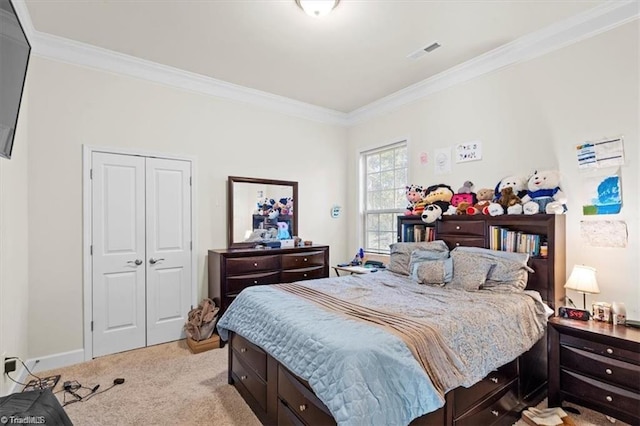 bedroom with light colored carpet, ornamental molding, and a closet