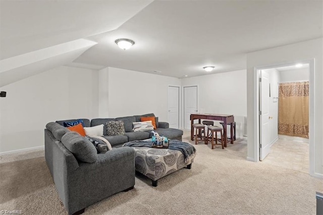 carpeted living room featuring vaulted ceiling