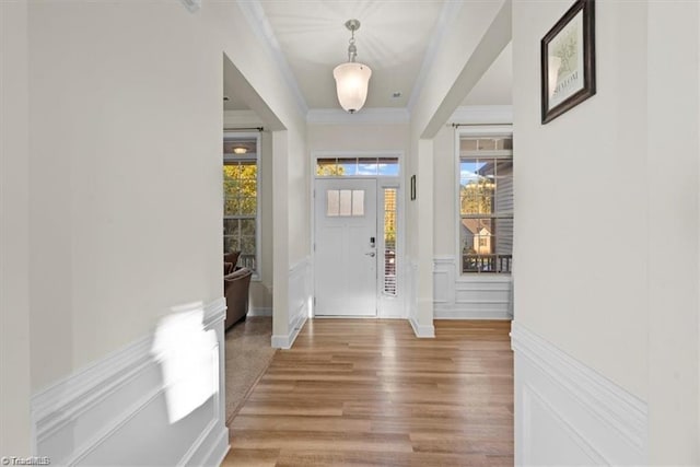 entryway with crown molding and hardwood / wood-style floors