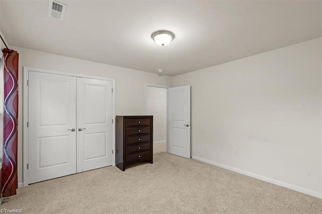 bedroom with light carpet and a closet