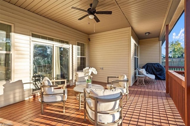 wooden terrace with ceiling fan and a grill