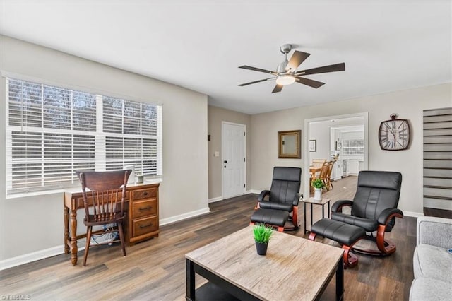 living room with hardwood / wood-style flooring and ceiling fan