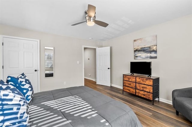 bedroom with dark hardwood / wood-style floors and ceiling fan