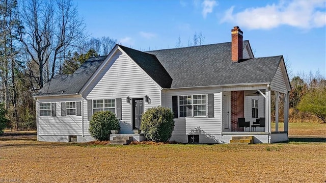 rear view of house featuring a lawn